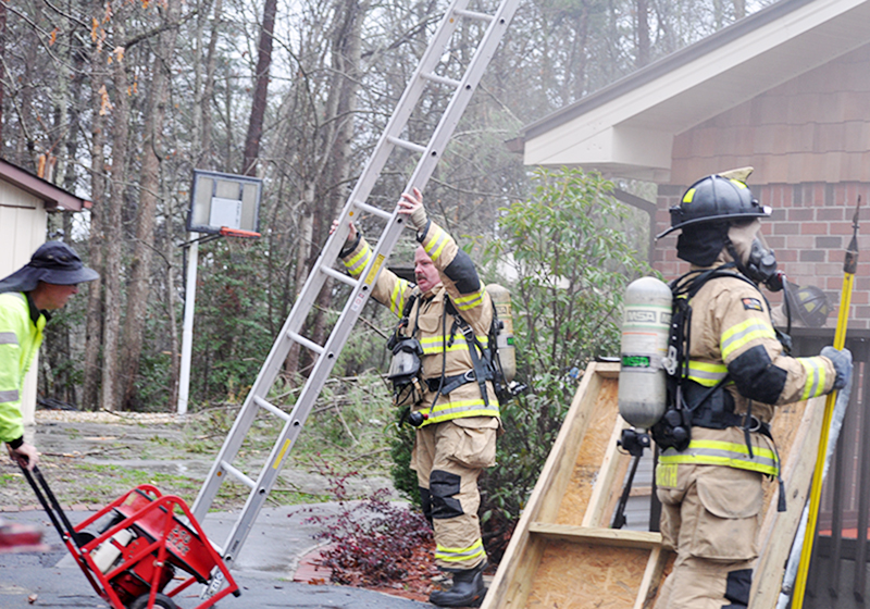 Fannin County firefighters, from left, Assistant Fire Chief Rob Ross, Bill Brown and Matthew Barth were among those battling a fire at 511 Scenic Drive Tuesday morning, March 24.