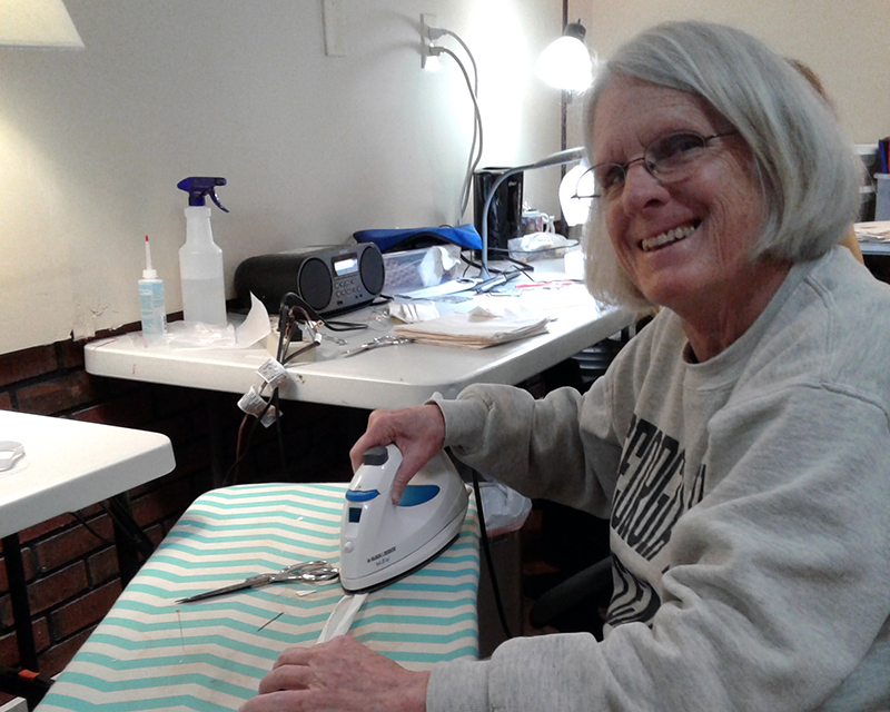 Sue Hoagland makes the seam binding straps for makeshift N95 masks Monday, March 23.