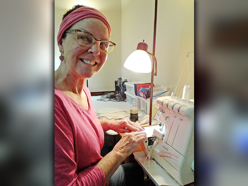 Renee Roberts was among several women to help create masks to alleviate the shortage of N95 masks. She is shown serging a mask.
