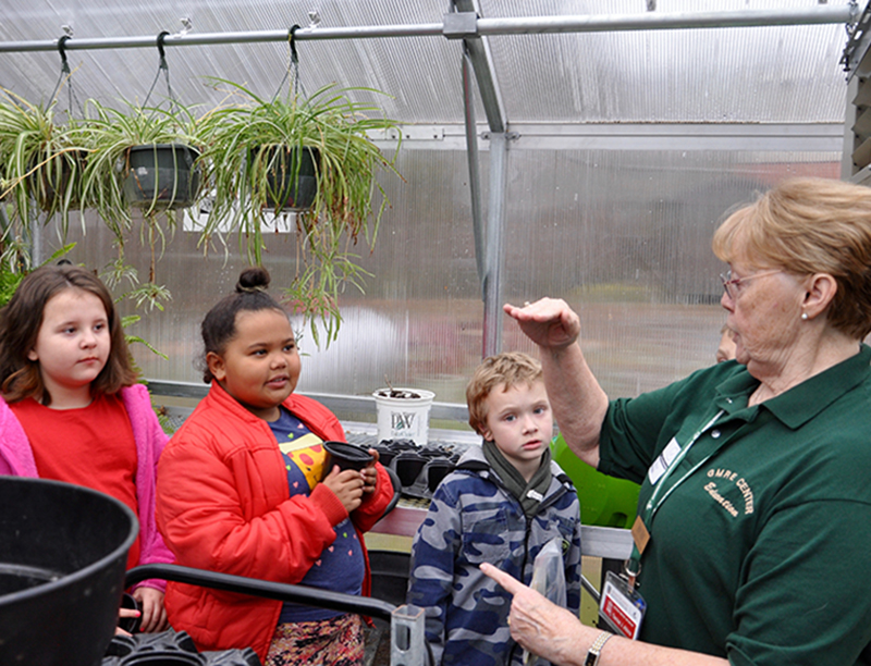 Master Gardener Denise Atkins, right, instructs East Fannin Elementary students on how to plant their seeds during a special class Monday, March 2. Listening attentively are, from left, Hadley Queen, Memori Sorensen and Cullen Kimsey.