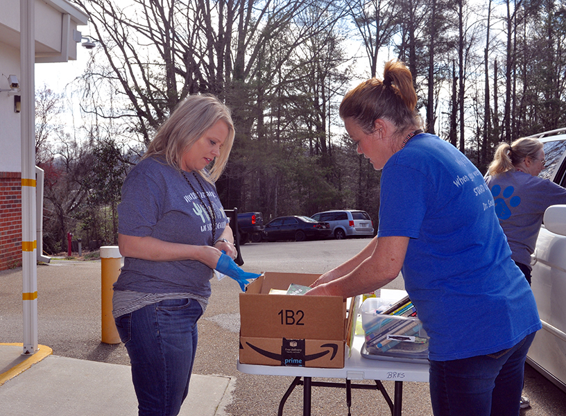 Fannin County School System staff members Jill Holloway, left, and Wendi Hood help prepare meals for Fannin County students to have during school closures Thursday, March 19.