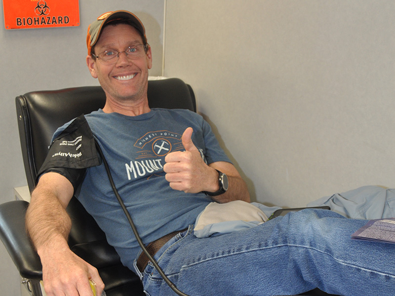 Volunteer Ronnie Holden gives a thumbs up as he gives blood Friday, March 27.