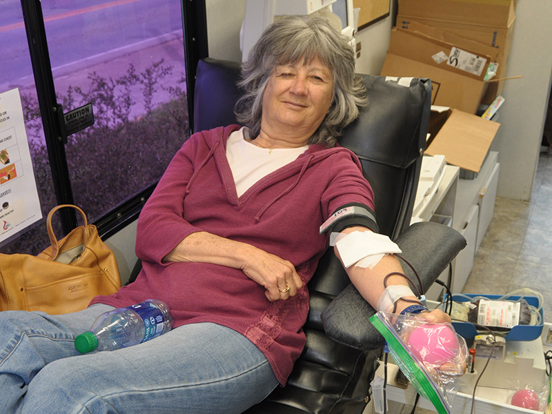 Volunteer Vicky Mauck smiles as she donates blood during the drive at Blue Ridge First Baptist Church Friday, March 27.