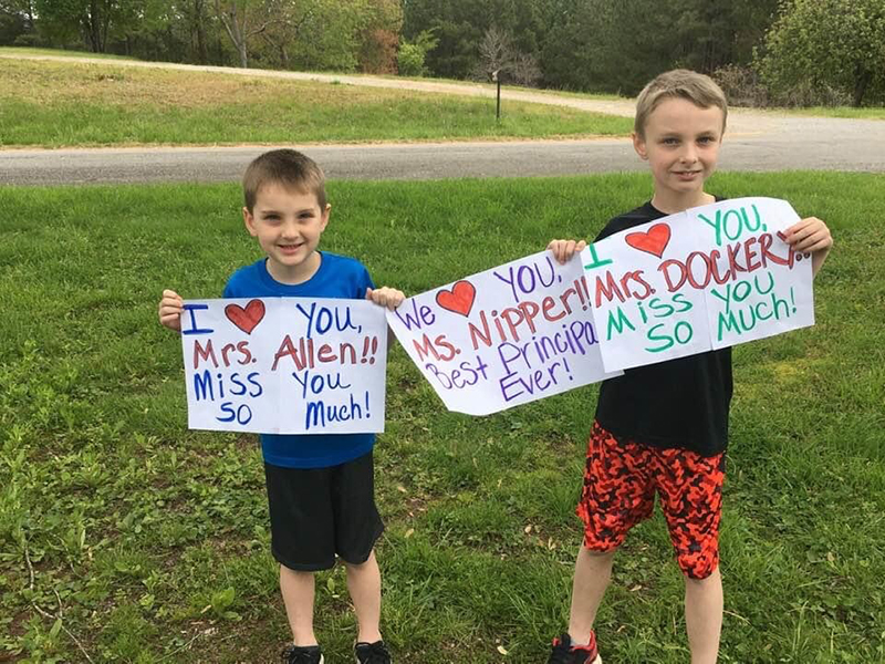 The teachers at Copper Basin Elementary School (CBES) couldn’t wait any longer to see their students, so they hoped in their vehicles and road around East Polk County waving and throwing candy to those who were waiting on them. Edward, left, and Robert Cole hold signs for their favorite teacher Wednesday, April 22, during CBES’s Teachers on the Town Parade.