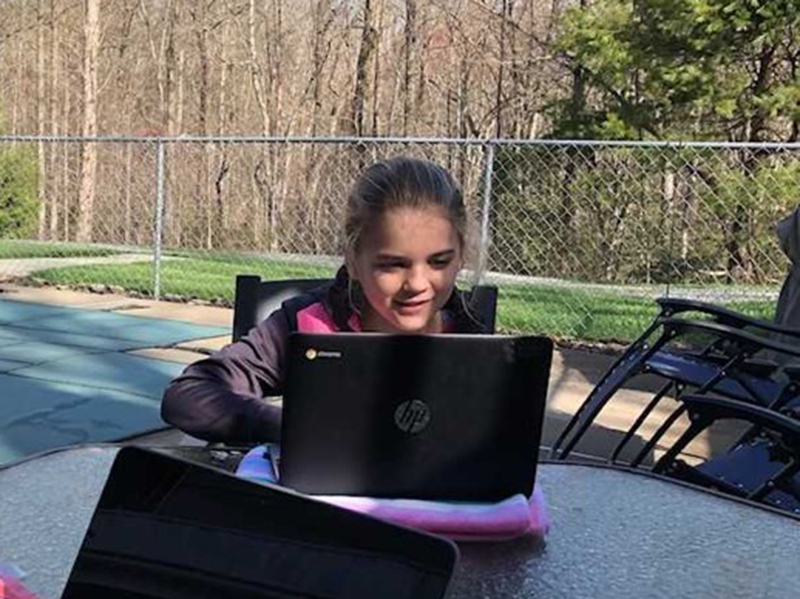 Blue Ridge Elementary School student Annaleigh Cheatham uses her school issued Chromebook to complete her digital learning.