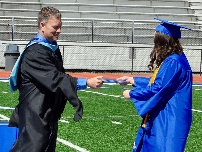 Haley Parks accepts her diploma from Fannin County High School Principal Erik Cioffi during a private graduation ceremony.