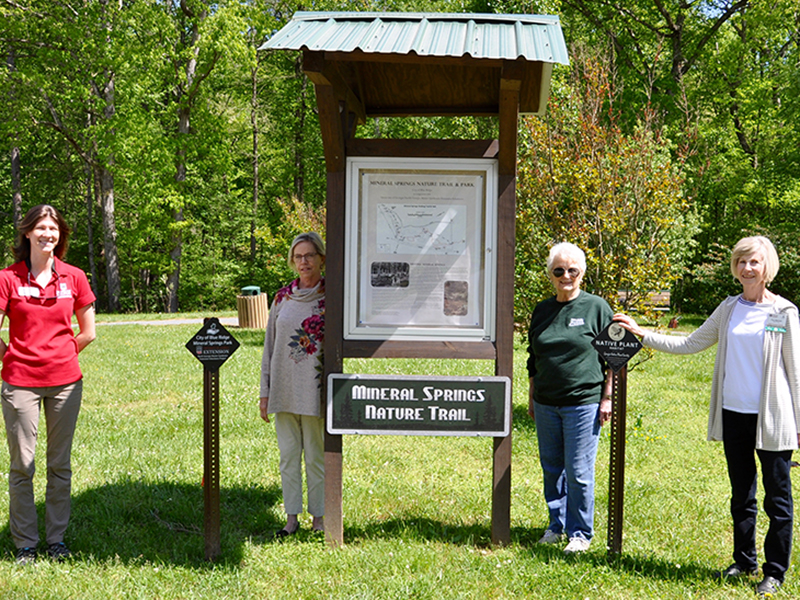 Standing beside the new signage at Mineral Springs Park in Blue Ridge are, from left, Fannin County Extension Agent Ashley Hoppers, North Georgia Master Gardeners Extension Volunteers (NGMGEV) Project Chair Alyce Wirtz, NGMGEV Wanda Jefferson and NGMGEV President Fran Stoecker.