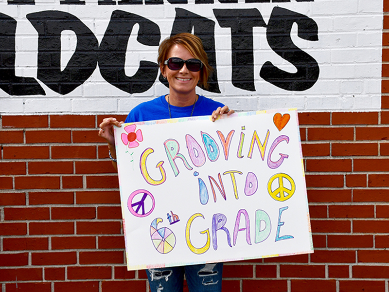 East Fannin Elementary School Third Grade Teacher Lora Robinson celebrates the school’s fifth grade students in a groovy way as they drive through the school’s Fifth Grade Parade Thursday, May 22.