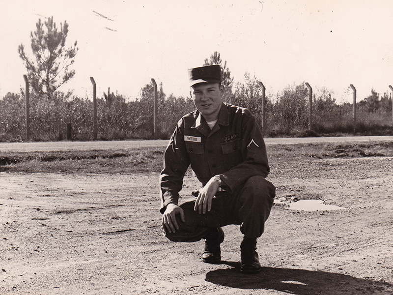 Private First Class Garnett Webb kneels in his uniform while on active duty with the U.S. Army. Webb joined the Army in 1959.