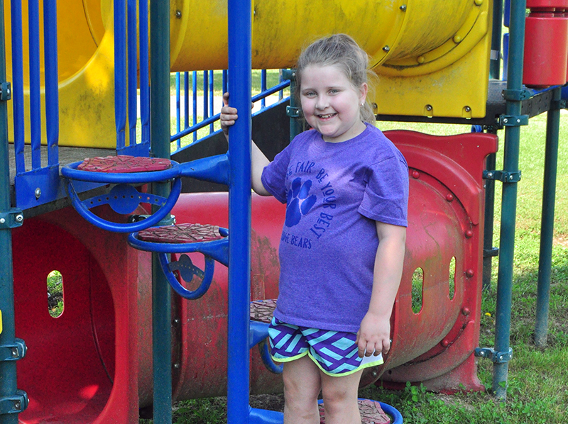 Lucy Mathis takes a break from playing on the playground to smile for a photo at the Fannin County Recreation Department’s Summer Camp Wednesday, June 3.	