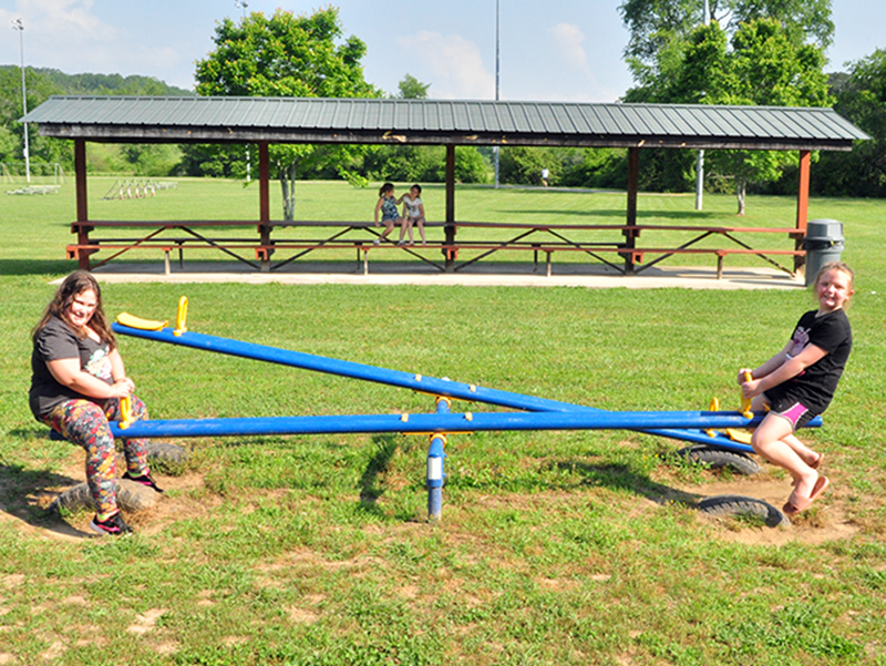 Baillie Traylor, left, and Kenna Wimpey play on the seesaw at the Recreation Department’s Summer Camp Wednesday, June 3.