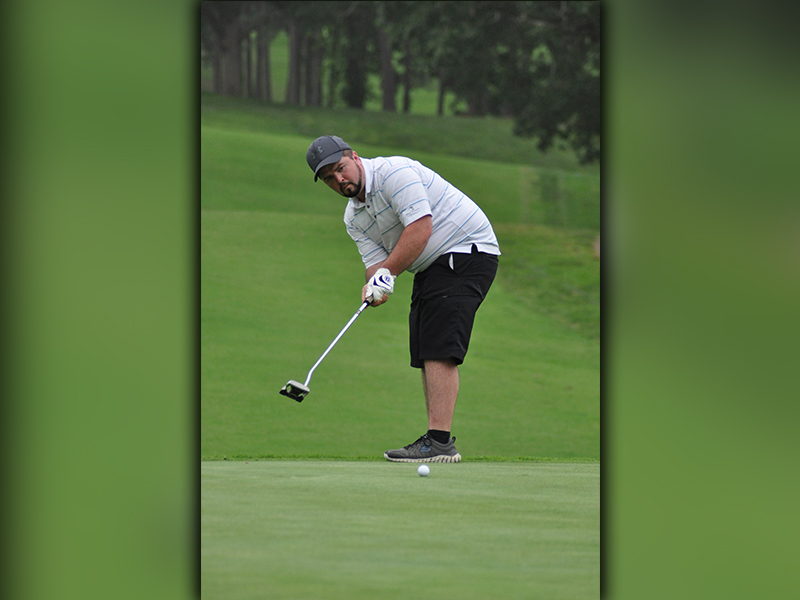 Local golfer Brett Trantham eyes a putt during the “Stars and Stripes Shootout” golf tournament Saturday, June 27.