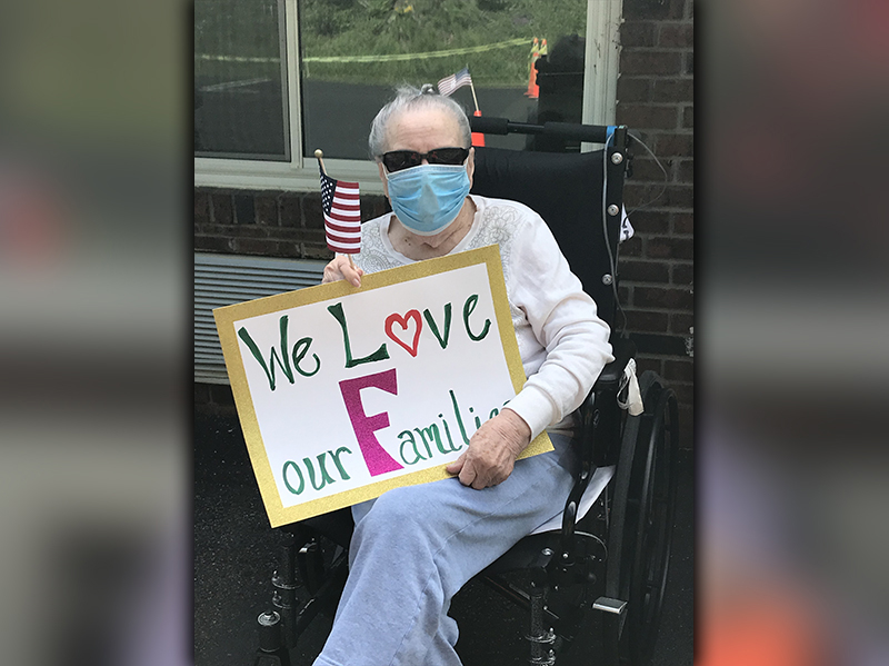 PruittHealth - Blue Ridge held a socially distanced drive-thru parade to lift the spirits of their residents Monday, May 25. Elsie Petty is shown letting the parade attendees know they love them.