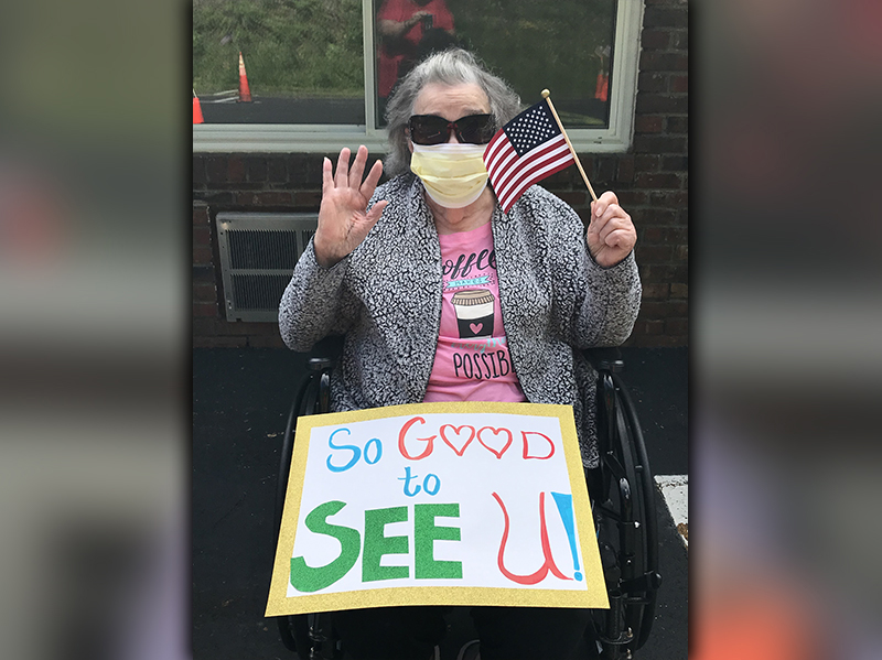 PruittHealth - Blue Ridge resident Juanita Burton held a sign expressing her excitement to see everyone during the center’s drive-thru parade on Memorial Day.