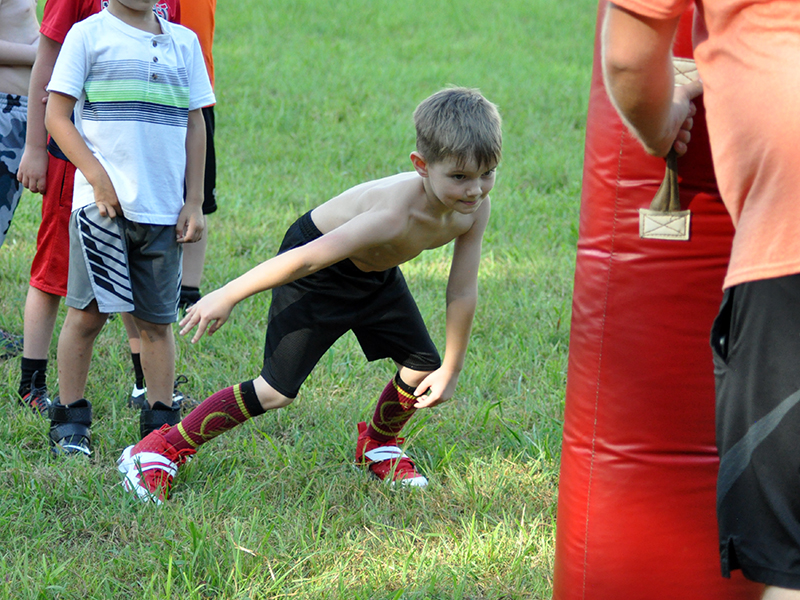 Camdon Sawyer practices his tackling during the Copper Basin Youth Sports football conditioning Thursday, July 16.
