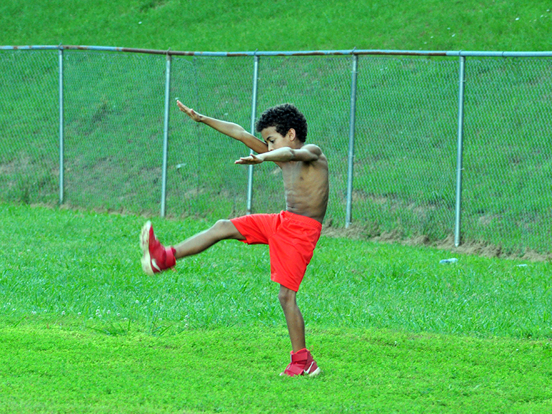 Kayden Loudermilk loosens up during the Copper Basin youth sports football conditioning Thursday, July 16.