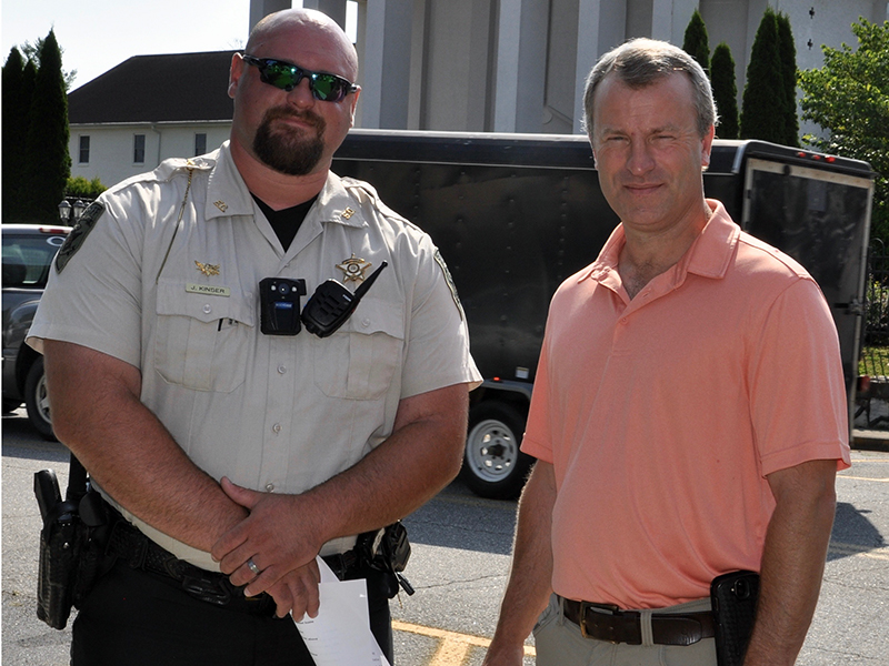 Fannin County Deputy Sheriff John Kinser, left, stands beside Sheriff Dane Kirby before the commencement of the Mountain Patriots’ Public Prayer Rally Saturday, July 18. The meeting was meant to pray for the nation, law enforcement officers and first responders.