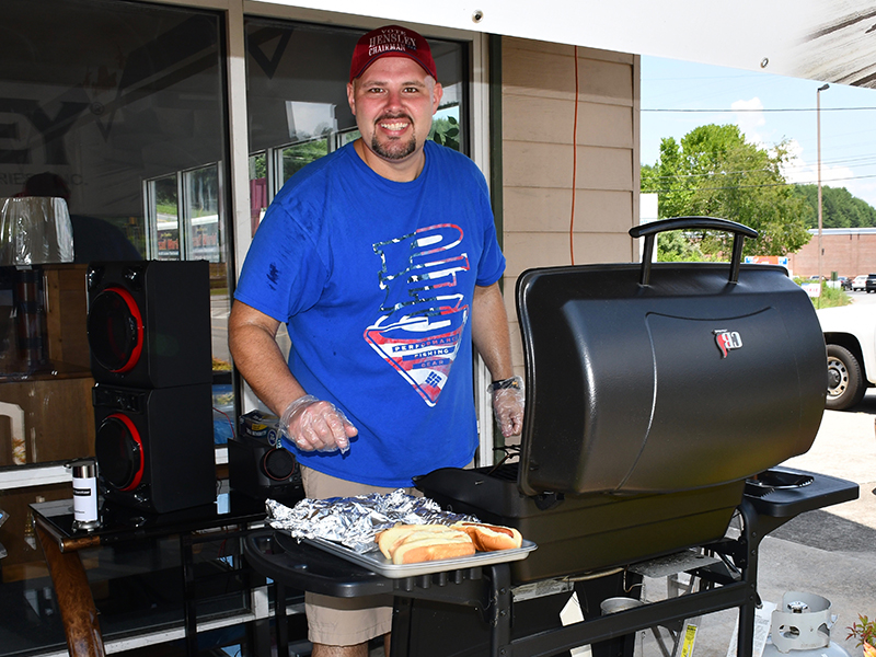 Jeremy Wright grilled hot dogs for attendees of the Cars for a Cause car show fundraiser hosted by Lovin Racing and Circuit World to benefit Fannin County Family Connection Sunday, July 19.