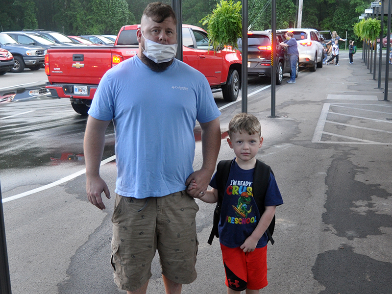 Mike Westphal walks his son, Gunner Westphal, to class on the first day of school for West Fannin Elementary School.