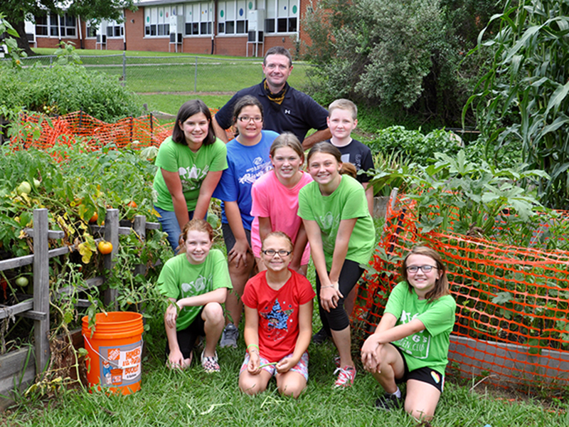 Copper Basin Elementary School’s Garden Club produces food for not only the young gardeners to take home, but also provides the community fresh produce. Gardeners are shown between some heirloom tomatoes and corn. Shown are, from left, front, Kendall Hughes, Madison Hester and Jalyn Hunt; middle, Raegan Farner, Gabby Lewis, Camryn Dockery and Emma Hester; back, advisor Gerome Smith and Silas Adams.