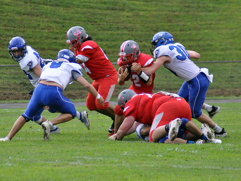 Sebastian Balilies (12) fights through defenders as Krus Sotos (54) and Chance Rollins (77) block  during the Cougars 14-12 win over Georgia Force Friday, August 28.