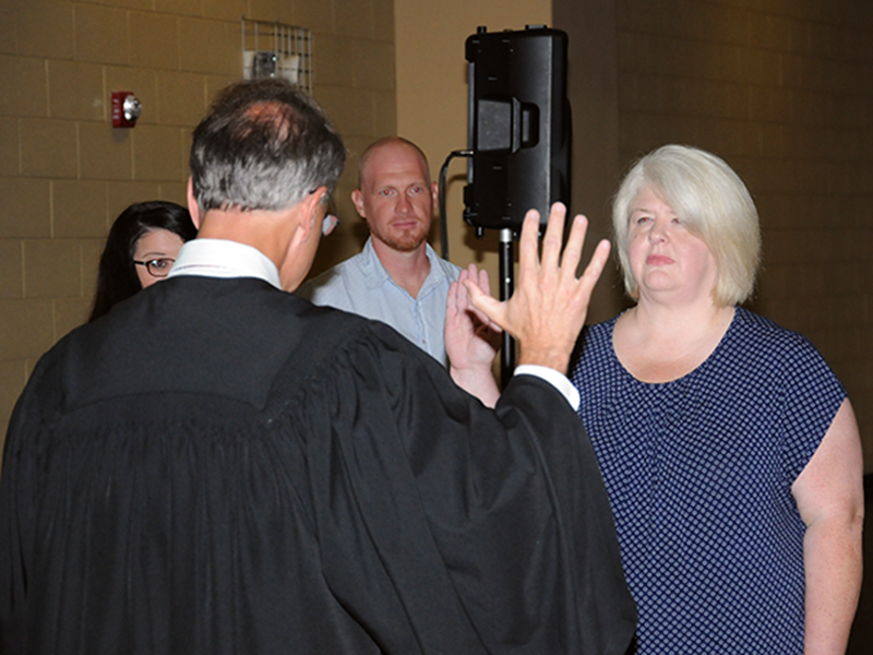 New Third District school board member Jill Crago Rose took her oath of office from Circuit Court Judge Mike Sharp.