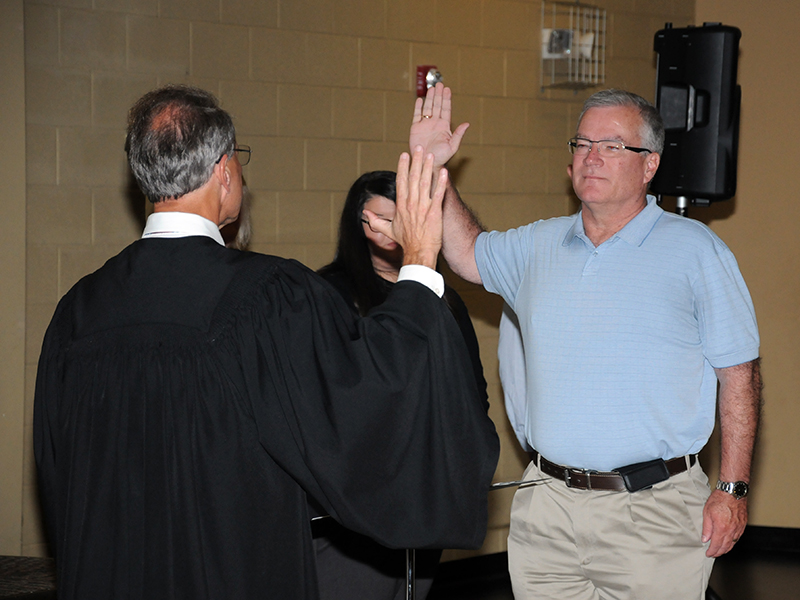 Robert “Robbie” Cole, who was re-elected to the school board from the Third District, took his oath of office from Circuit Court Judge Mike Sharp.