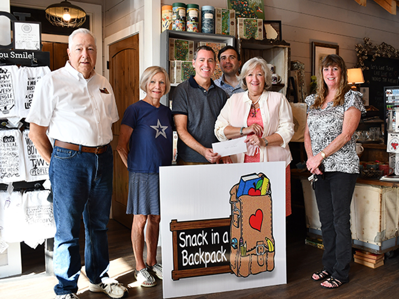 Blue Ridge Cotton Company and Gather raised $5,005.44 for Snack in a Backpack through their 1% charity program in honor of their son, Michael. Shown are, from left, Snack in a Backpack board members Jeff O’Neill and Toots Greene, Owners Gary Steverson and Joshua Durst, Executive Director Debby Beck and board member Jeanie May.