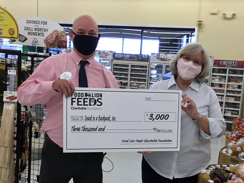 Blue Ridge Food Lion Store Manager Jeff Jones recently presented Snack in a Backpack Executive Director Debby Beck with a check for $3,000 on behalf of the Food Lion Feeds Charitable Foundation to go toward feeding the children of Fannin County.