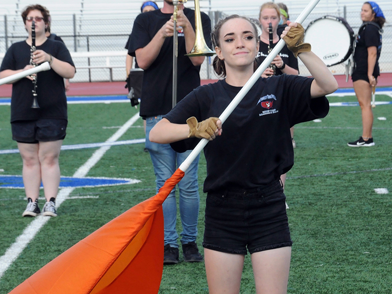 Fannin County High School Marching Band colorguard member Shayna Bolmon tightly grips her flag pole while performing to the crowd at the Friday, August 28, halftime show.