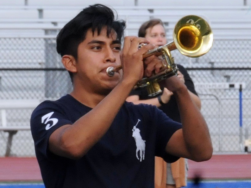 Kendel Vicente-Vicente plays his trumpet for a crowd at the first halftime performance of the year.