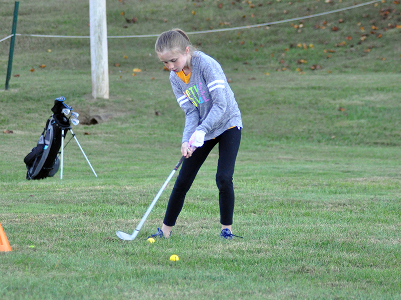 Eisley Barber works on hitting with her irons during the Recreation Department golf practice Tuesday, October 13.