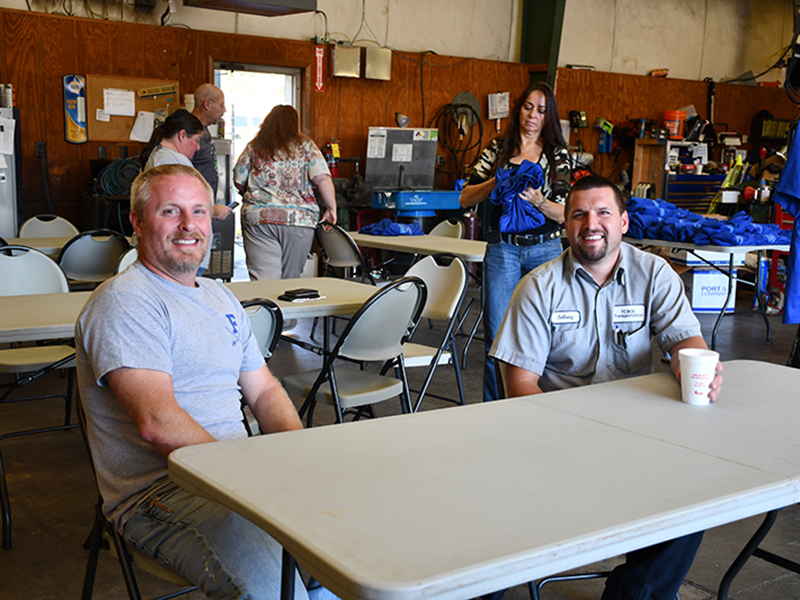 Fannin County School System bus drivers Brandon Tipton, left, and Anthony Rymer enjoy fellowship as they and their fellow bus drivers are honored during a School Bus Safety Week luncheon Thursday, October 22.