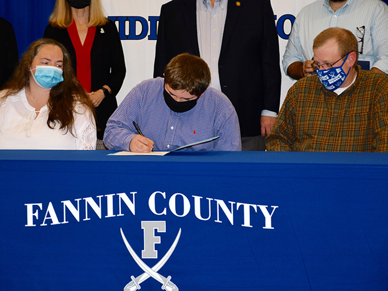 Fannin County Middle School student Wyatt Payne was one of five students to become Realizing Educational Achievement Can Happen (REACH) scholars during the annual REACH Signing Ceremony Wednesday, October 21. He is shown with his parents Kim and Jodi Payne.
