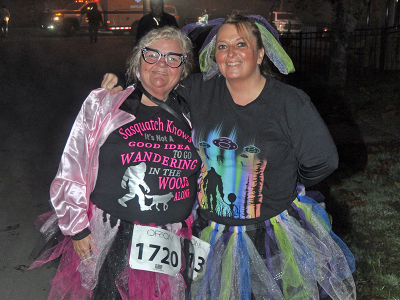 Teresa Hopkins, left, and Tracey Barcenas show off their costumes before the Bigfoot Boogie 5K Saturday, October 31.