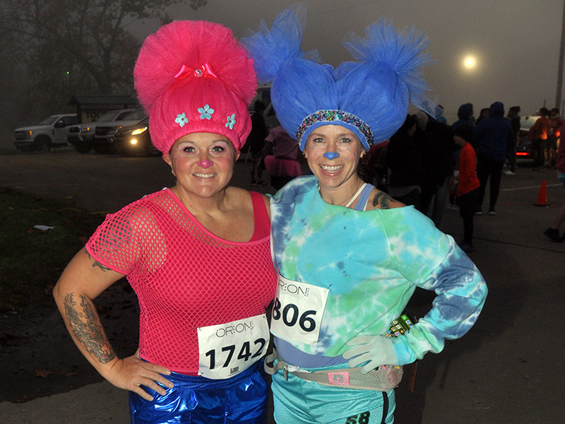 Amanda Ash, left, and Chris Disser prepare to run in their costumes at the Bigfoot Boogie 5K race Saturday, October 31.