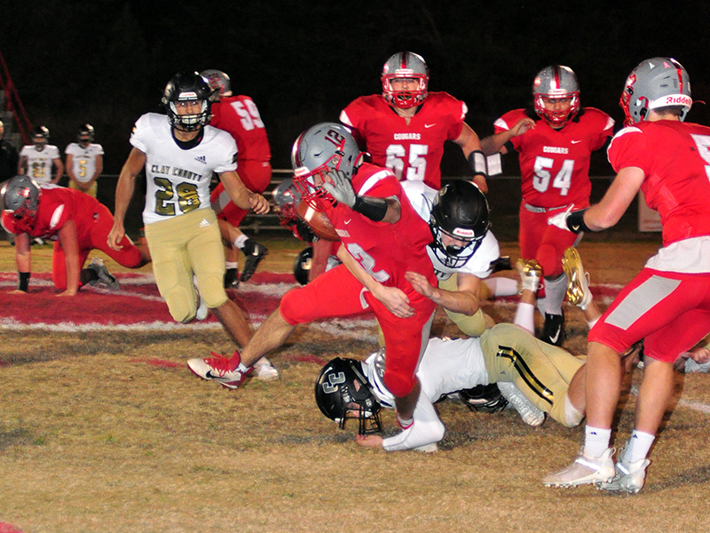 Sebastian Balilies (12) sheds a tackle during the Cougars game against the Clay County Bulldogs Friday, November 6.