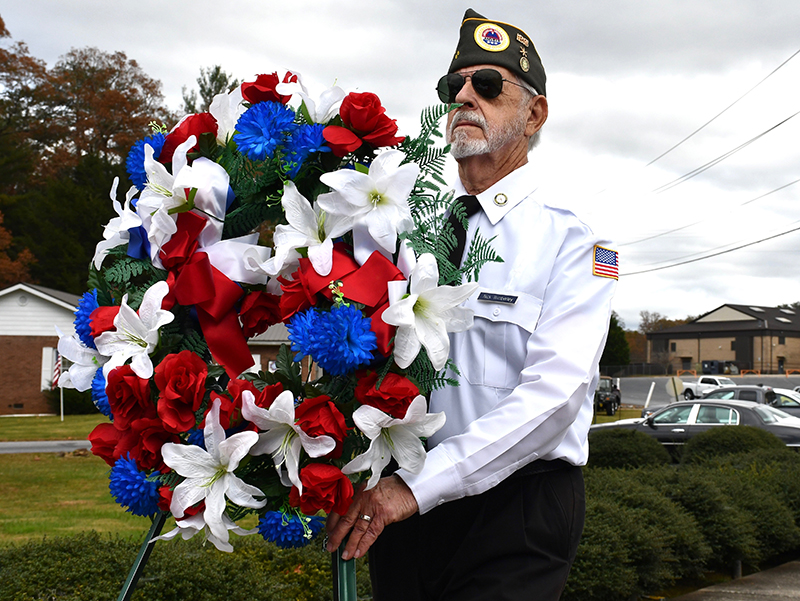 North Georgia Honor Guard member Nick Wimberley carries in a wreath in honor of the veteran lives lost during Fannin County’s Veterans Day ceremony Saturday, November 7.