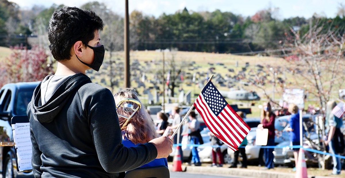Fannin County Middle School student TJ Dunn waved the American Flag as area veterans drove by during the school’s drive-thru Veterans’ Day Parade Friday, November 6.