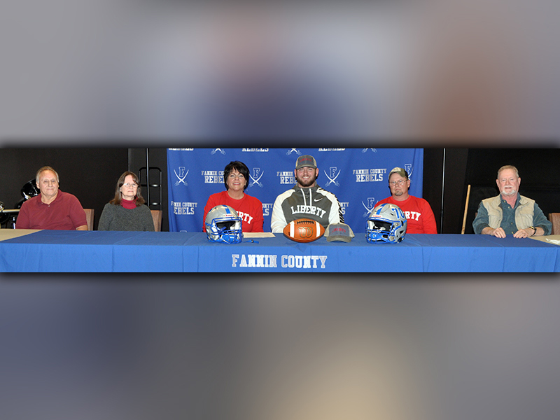 Fannin County football senior Mason Bundy signed to play football with the Liberty University Flames Wednesday, December 16. Shown following the signing are, from left, Jerry Garren, uncle; Cindy Garren, aunt; Dena Johnson, mother; Bundy; Chris Johnson, father; and Scott Johnson, uncle.
