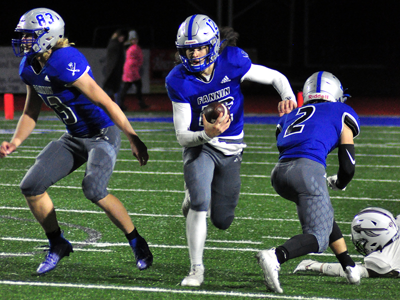 Luke Holloway (12) keeps the ball for first down during the Rebels game against Heard County Friday, December 4.
