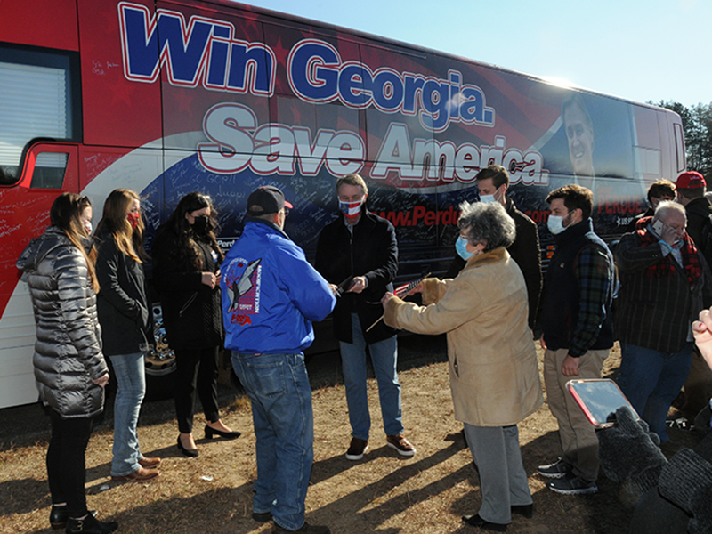 U.S. Senator David Purdue, facing a January 5 runoff election to retain his seat, met with supporters, signed autographs and had pictures made when his "Win Georgia, Save America" campaign came to Fannin County last week.