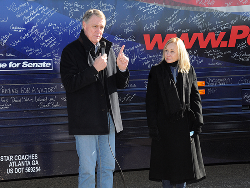 U.S. Senator David Purdue, with his wife, Bonnie, at his side, makes one of several points during his "Win Georgia, Save America" campaign that stopped in Fannin County last week. 