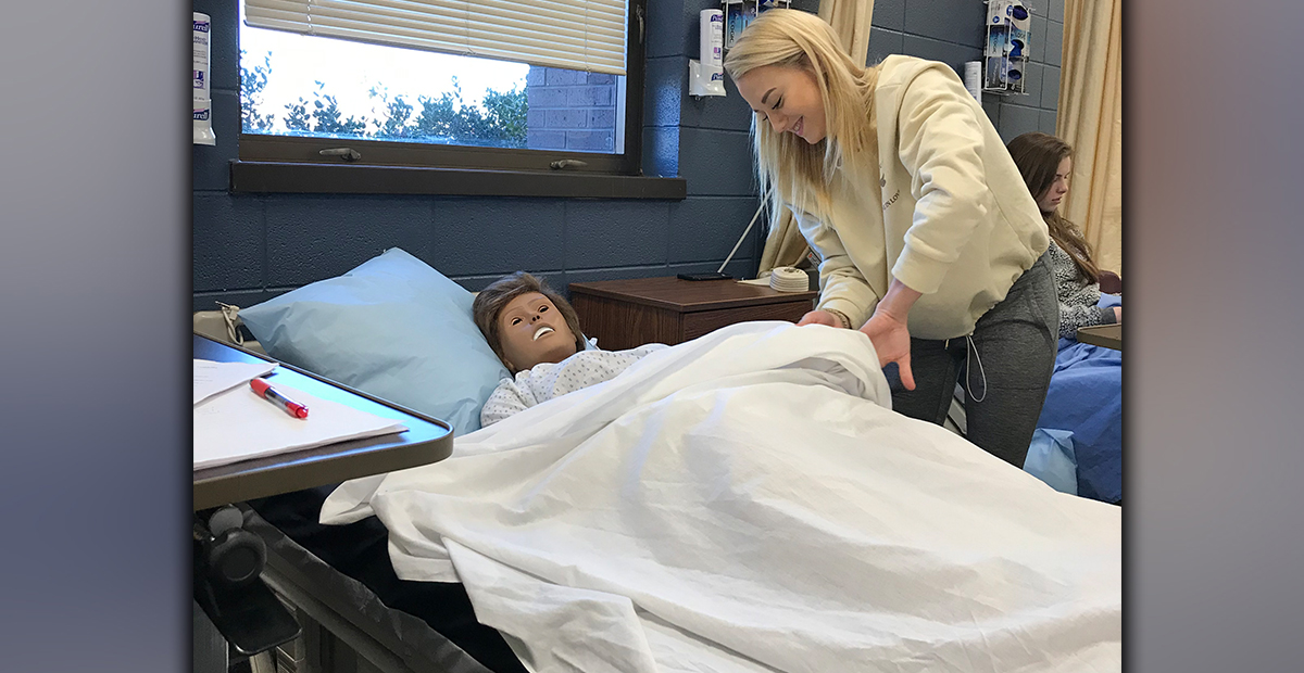 Fannin County High School student Mackenzie Johnson practices the skill of repositioning a dependent patient on their side in Healthcare Science teacher Anne Gibbs’ Patient Care Fundamentals course, which is one of the courses offered in the Healthcare pathway where students can gain state certifications.