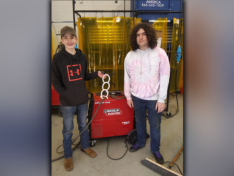 Fannin County High School welding students Ryan Pawlak, left, and Corey Riendeau are shown with a holiday snowman, which they welding using horseshoes.