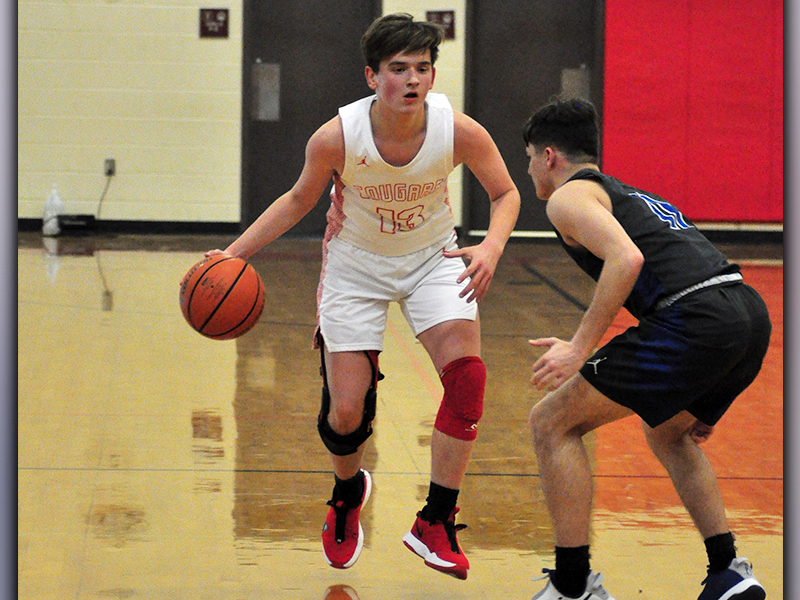 Evan Bobo dribbles past a Towns County defender during the Cougars game against the Indians Monday, January 18.