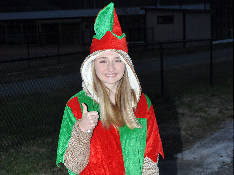 Santa’s helper, Taylor Tarpley, is all smiles and thumbs up as she gets ready to hand out goodies to young visitors during Santa’s visit to the Fannin County Recreation Center Wednesday, December 23.