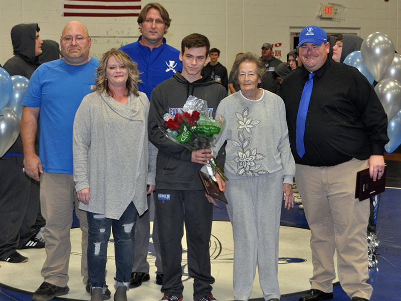 Caleb McTaggart was one of the seven seniors honored during Fannin County High School‘s wrestling team senior night Friday, January 15. Shown during the ceremony are, from left, father, Roger McTaggart, mother, Glenda McTaggart, Coach Alan Collis, McTaggart, grandmother, Henrietta Cochran, and Coach Chuck Patterson.