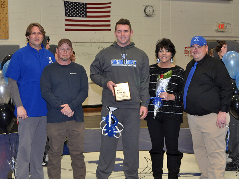 Senior Mason Bundy was recognized with six other seniors during Fannin wrestling senior night, Friday, January 15. Shown during the cermony are, from left, Coach Alan Collis, father Chris Johnson, Bundy, mother, Deana Johnson, and Coach Chuck Patterson.