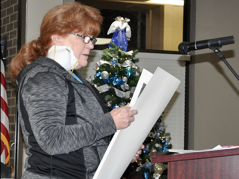 Donna Thompson, left, presents screenshots of a Facebook interaction with Planning Commission Chairman John Soave in which he provided misinformation regarding what can be built under a General Commercial zoning.